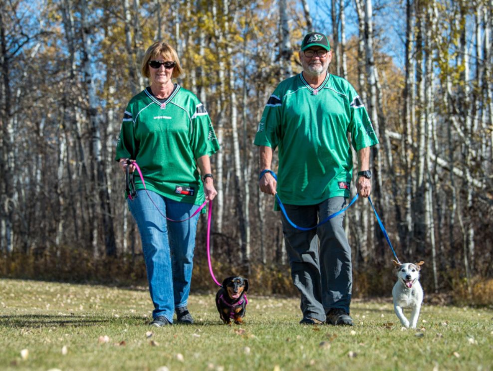Larry and Sheryl Busser walking their dog.