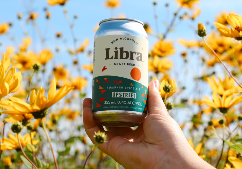 Holding a can of Libra non-alcoholic beer.